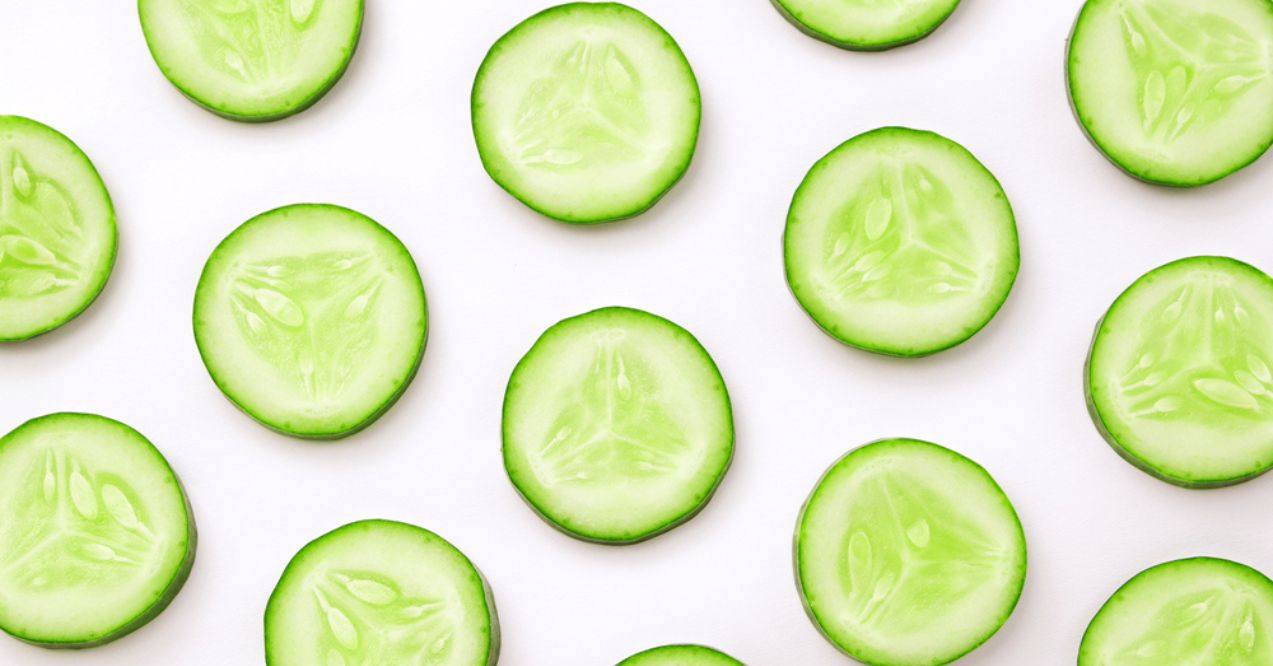 Slices of cucumber arranged on a white background