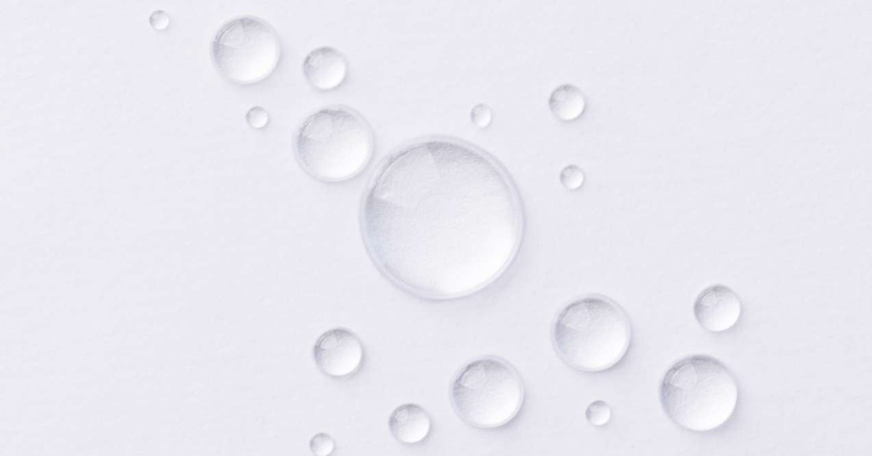 Clear serum drops on a white background