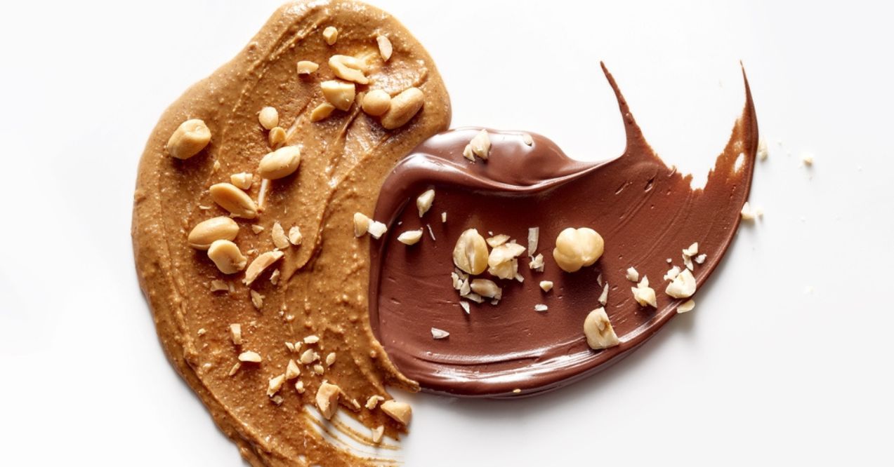 A smear of peanut butter and chocolate spread with chopped nuts