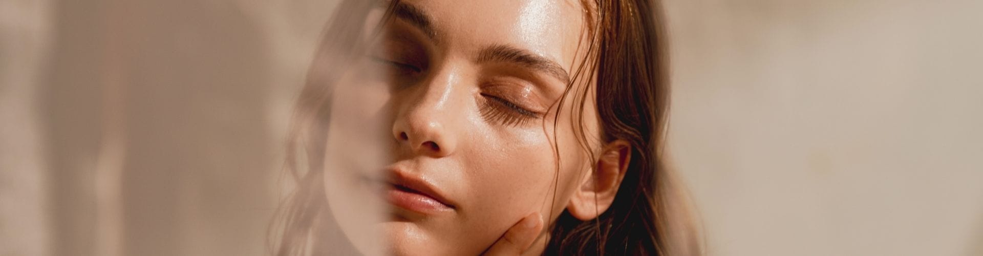 Relaxed woman with glowing skin, symbolizing self-care