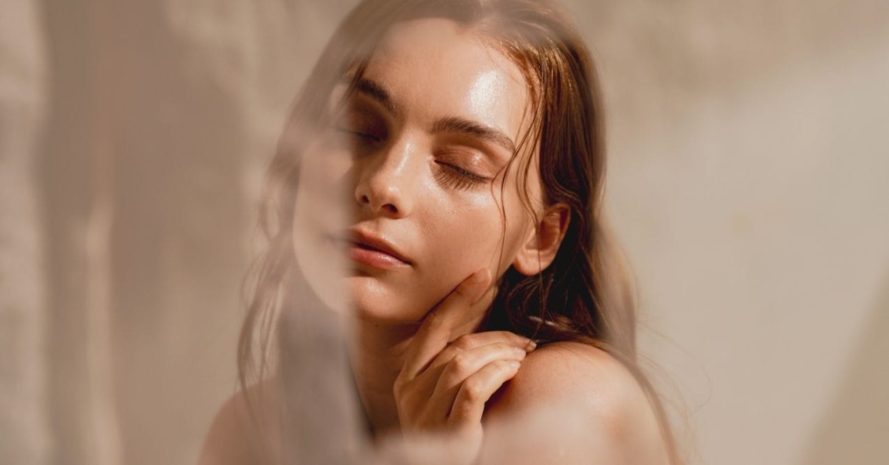 Relaxed woman with glowing skin, symbolizing self-care