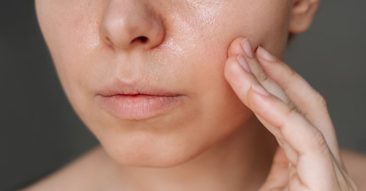 Close-up of a person touching their cheek