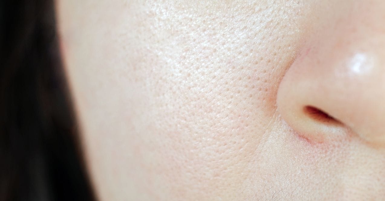 Close-up of skin with visible pores and slight texture near the nose