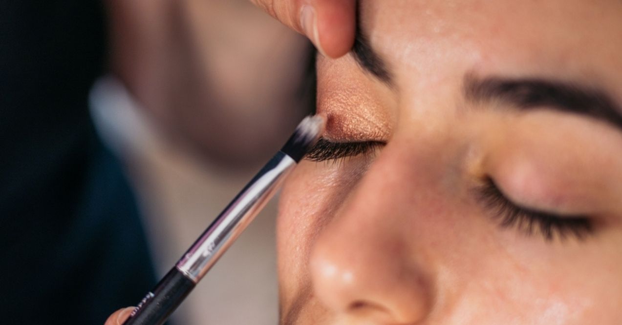 Close-up of a woman having eyeshadow applied