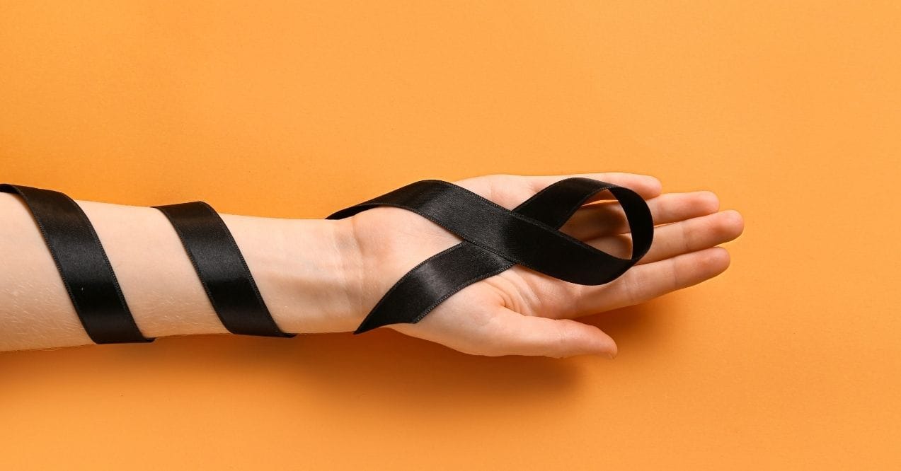 Black ribbon on a hand, symbolizing melanoma awareness