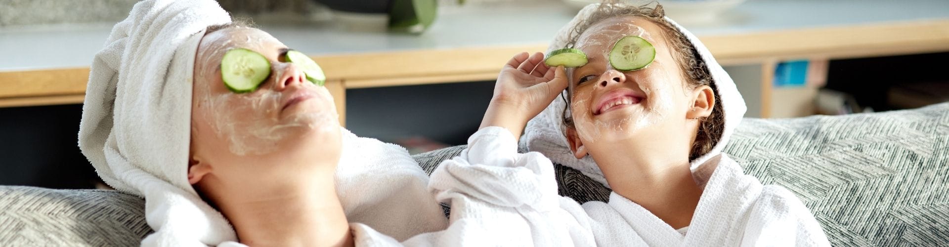 Mother and child enjoying a spa day with cucumber slices on their eyes