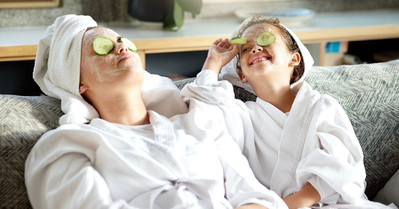 Mother and child enjoying a spa day with cucumber slices on their eyes