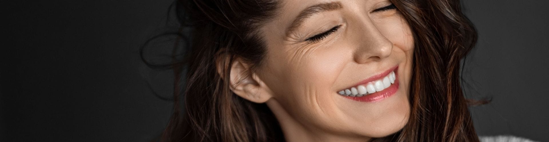Woman smiling with visible smile lines
