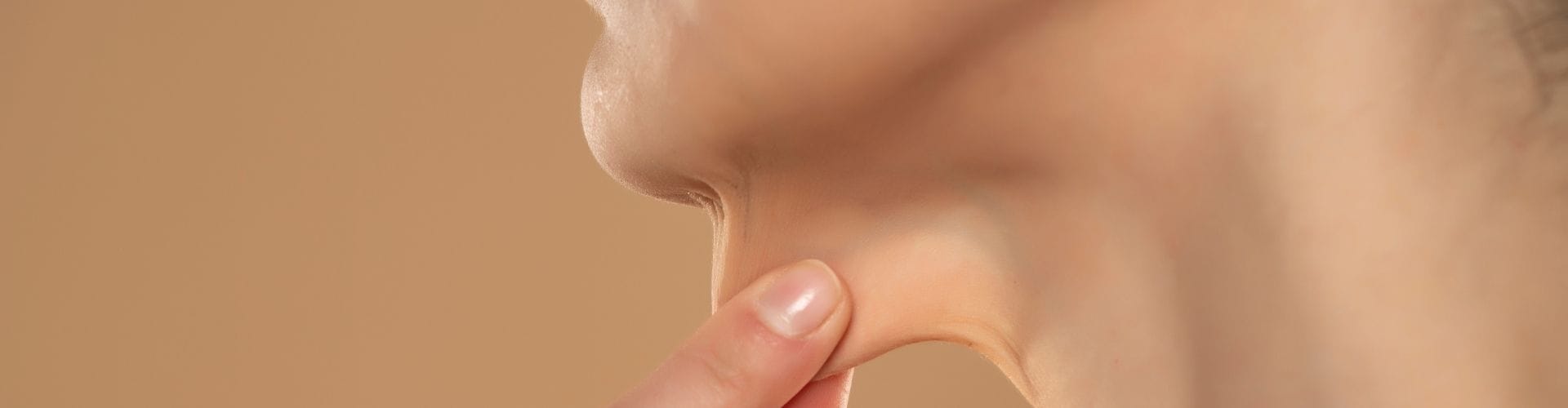Hand pinching loose neck skin