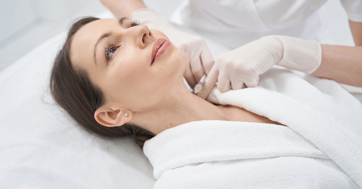 Woman receiving neck skin treatment