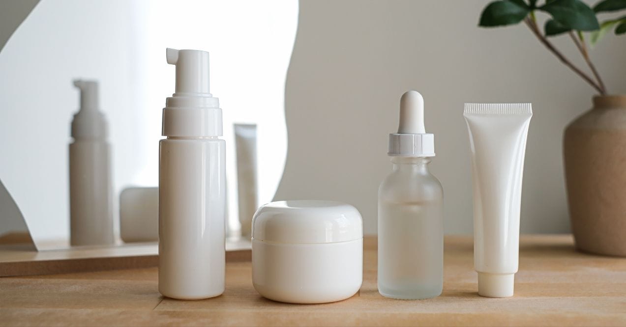 Four essential skincare products with a simple design