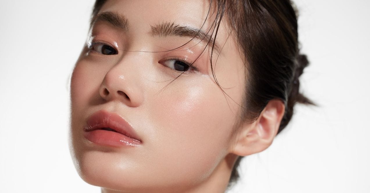 Close-up of woman with glass skin, showing smooth, shiny, and luminous complexion