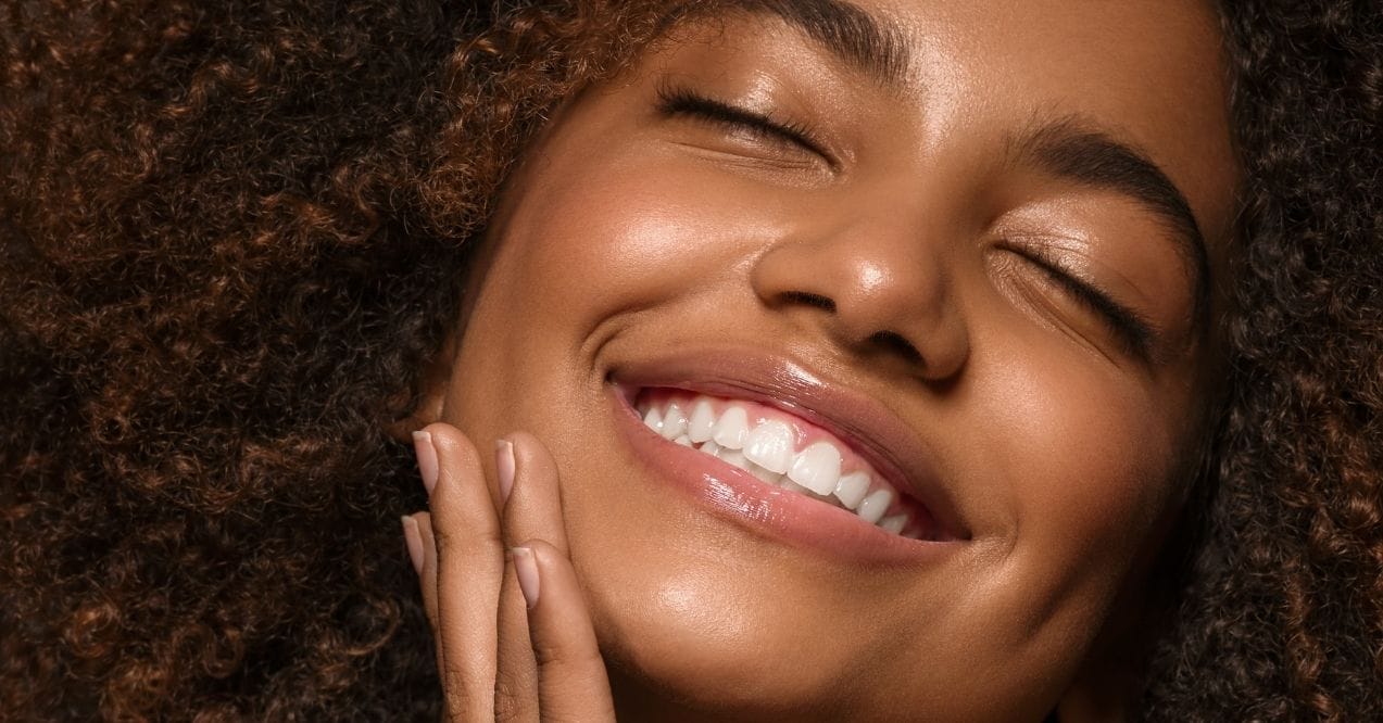 Close-up of smiling woman with eyes closed