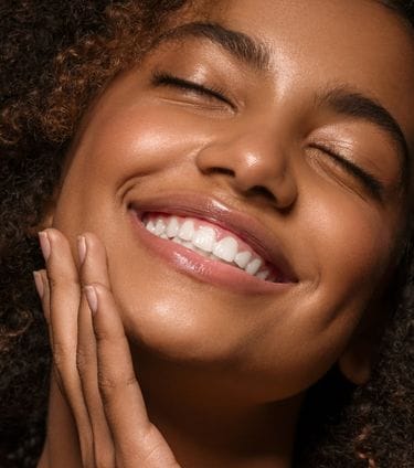 Close-up of smiling woman with eyes closed
