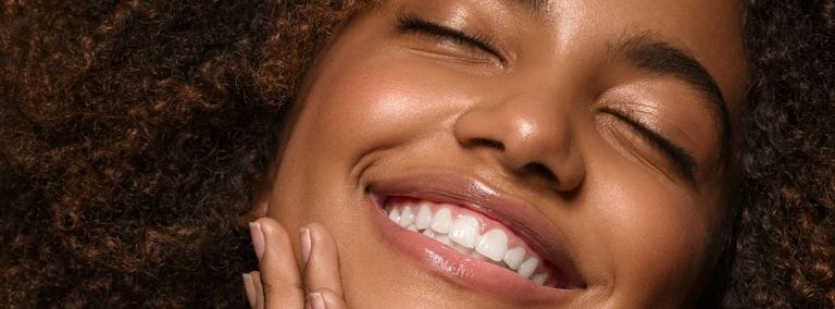 Close-up of smiling woman with eyes closed