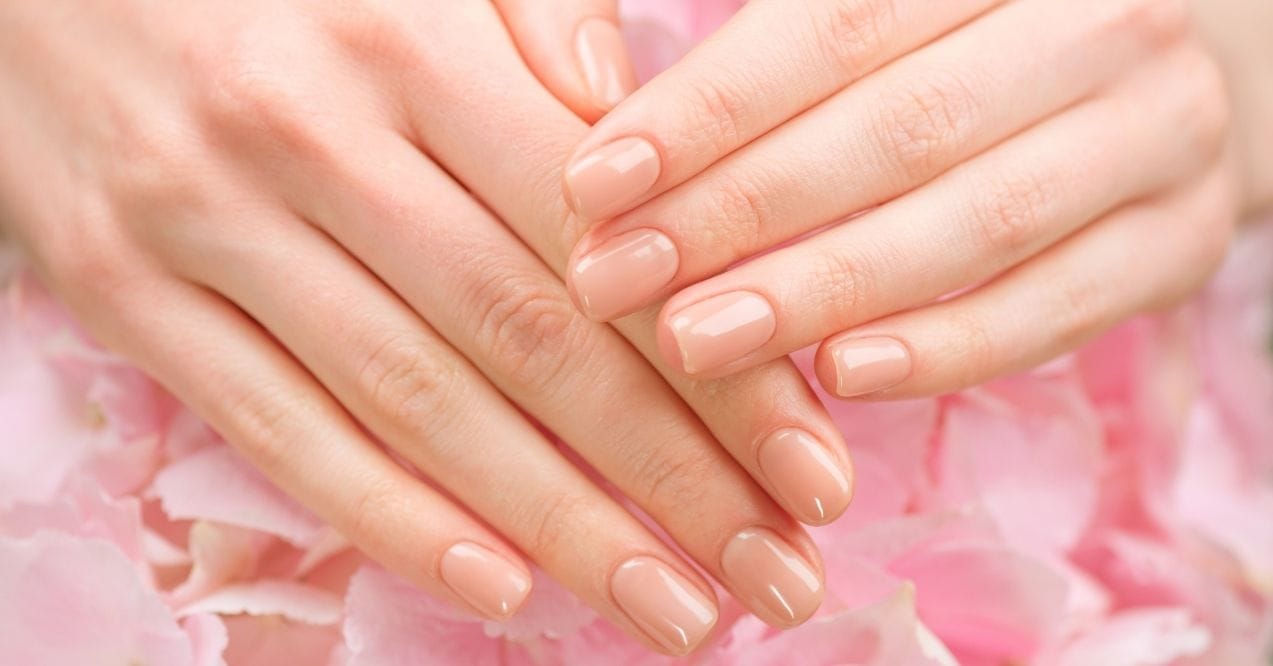 Close-up of manicured hands with nude polish