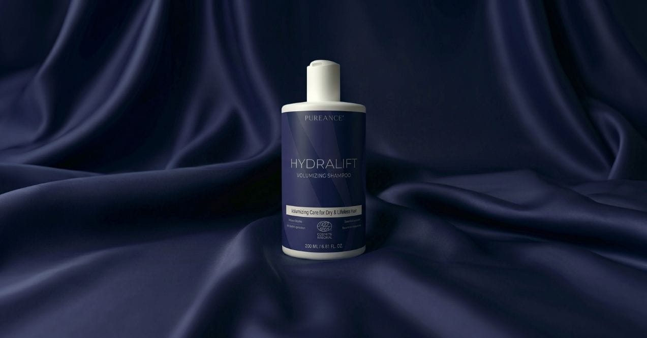 Pureance HydraLift Volumizing Shampoo bottle on dark blue satin fabric